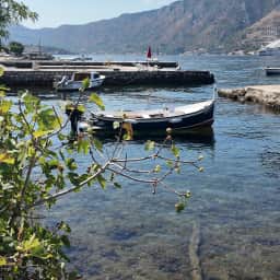 Wooden boats moored along a pier in Dobrota.