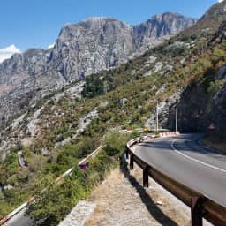 The serpentine mountain road above Kotor, its hairpin bends stacked up the bare rock slope of the pass.