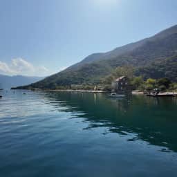 The Morinj cove where the millstream meets the bay, stone houses under the karst slope