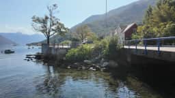 The road bridge over the stream mouth at Morinj, boats on the still water beside it