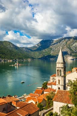 Perast's bell tower and the island church of Our Lady of the Rocks across the Bay of Kotor