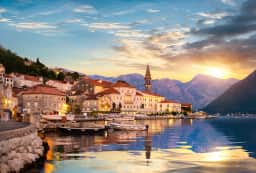 Sunset over Perast's waterfront and bell tower on the Bay of Kotor