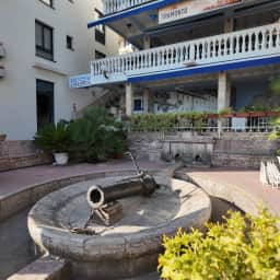 An old stone fountain set among weathered masonry in the old town.