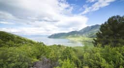 The village of Virpazar on the edge of Lake Skadar, with small tour boats moored along its waterfront where trips to the lake and the fortress set off.