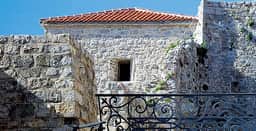 Stone buildings and iron railing within Budva Citadel