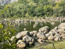 The spring-fed pool of the Ljuta river at Stari Mlini, clear green water over pale stones