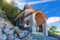 Our Lady of Remedy church above Kotor beneath the rocky slope