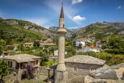 Stone mosque and minaret below the Rumija slopes at Stari Bar
