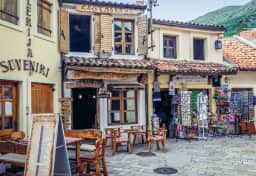 Cafes and craft displays along the stone bazaar street below Stari Bar