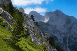 Steep limestone walls rising above forest on Komovi