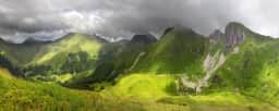 Cloud shadows moving over green mountain ridges near Kolašin