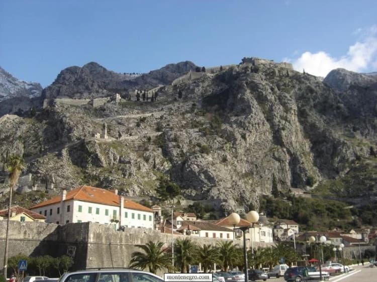 Historic Montenegro.com view of Kotor’s walls rising above stone roofs