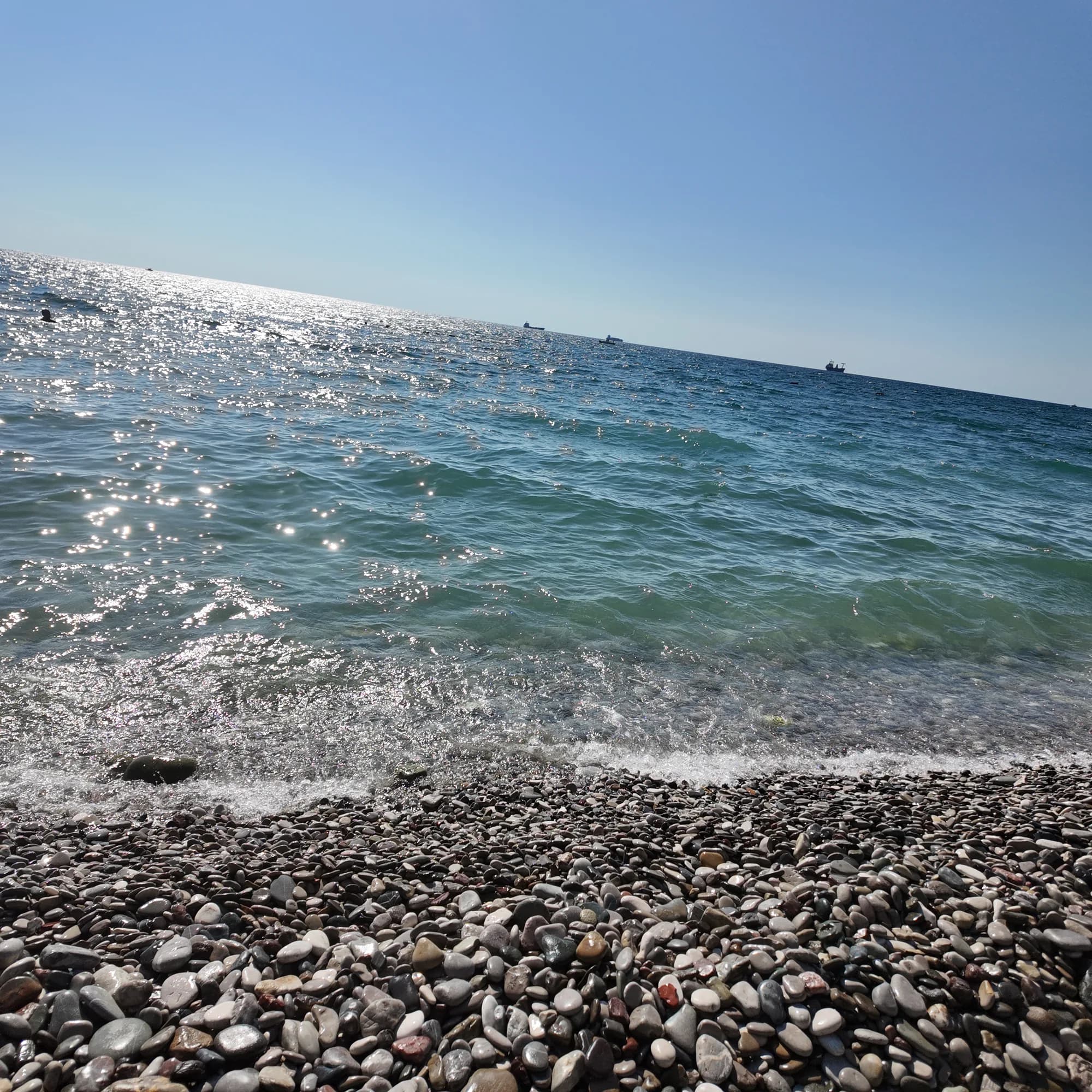 Grey and white pebbles at the waterline of Žukotrlica