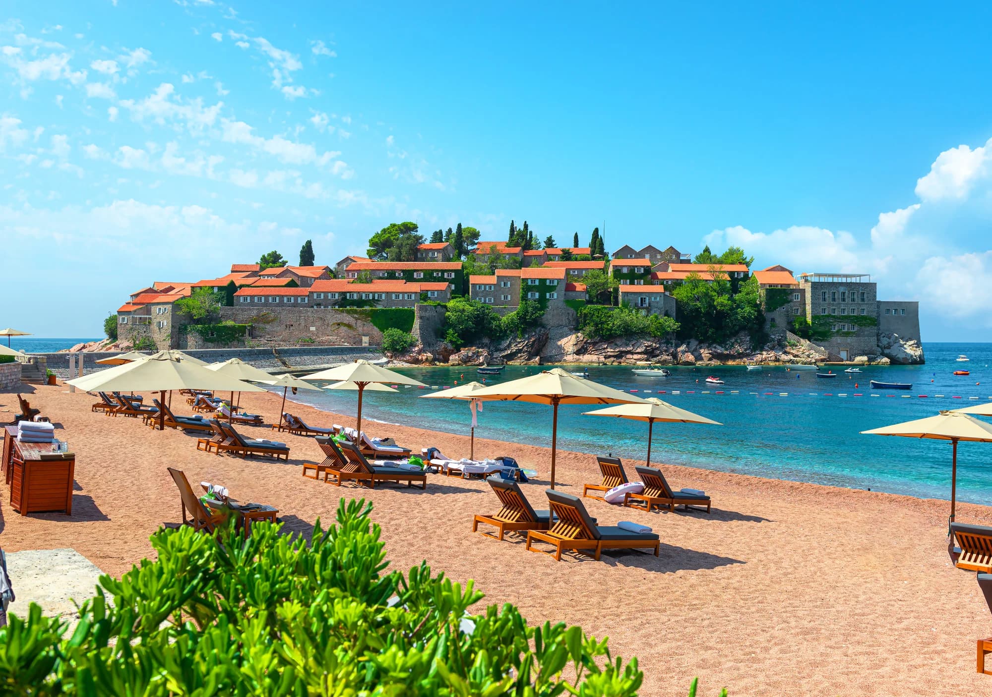 The fortified islet of Sveti Stefan and its causeway from the mainland beach