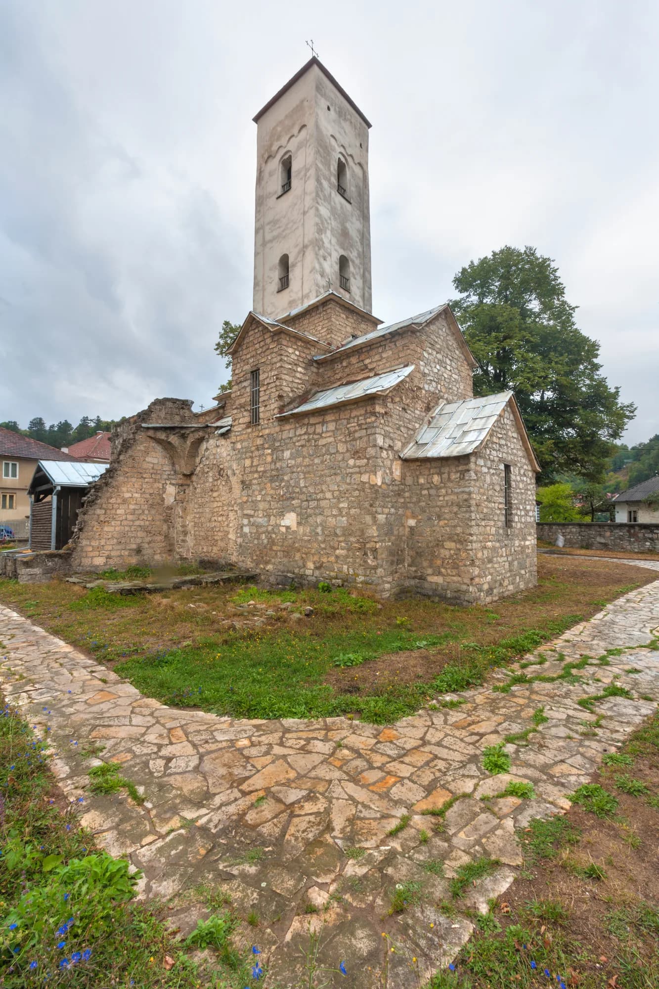 The church of St Peter and Paul in Bijelo Polje, twelfth-century stone with its tall belfry, on a paved terrace