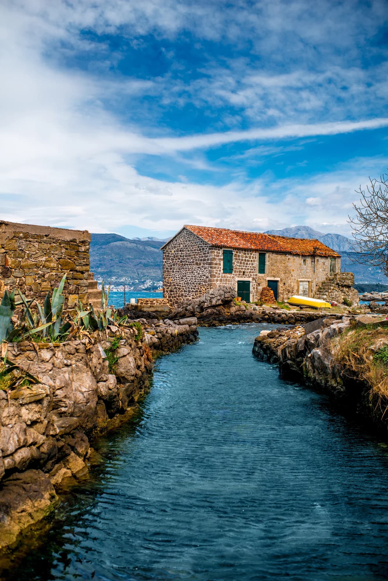 The channel at Bjelila looking out to sea, the old stone house on the rocks beyond