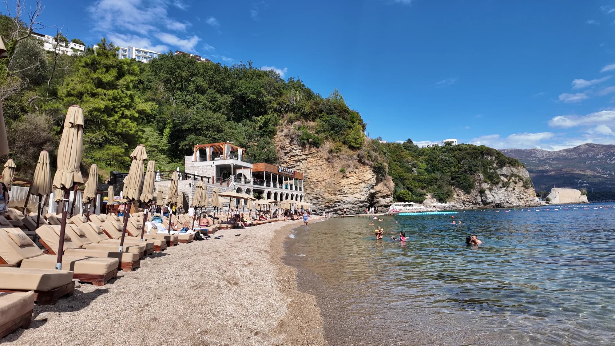 Mogren II, the second cove, with its restaurant terrace and the rocks between the two beaches
