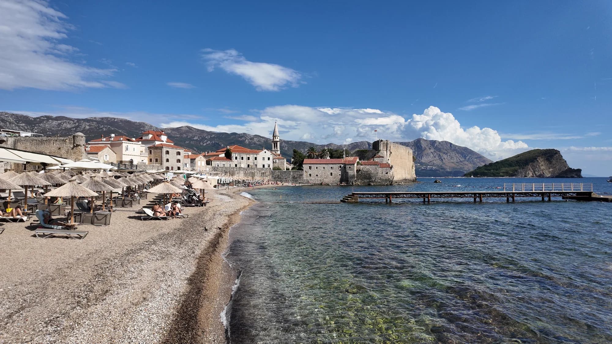 Ričardova glava beach and its pier below the Old Town walls, with Sveti Nikola in the distance