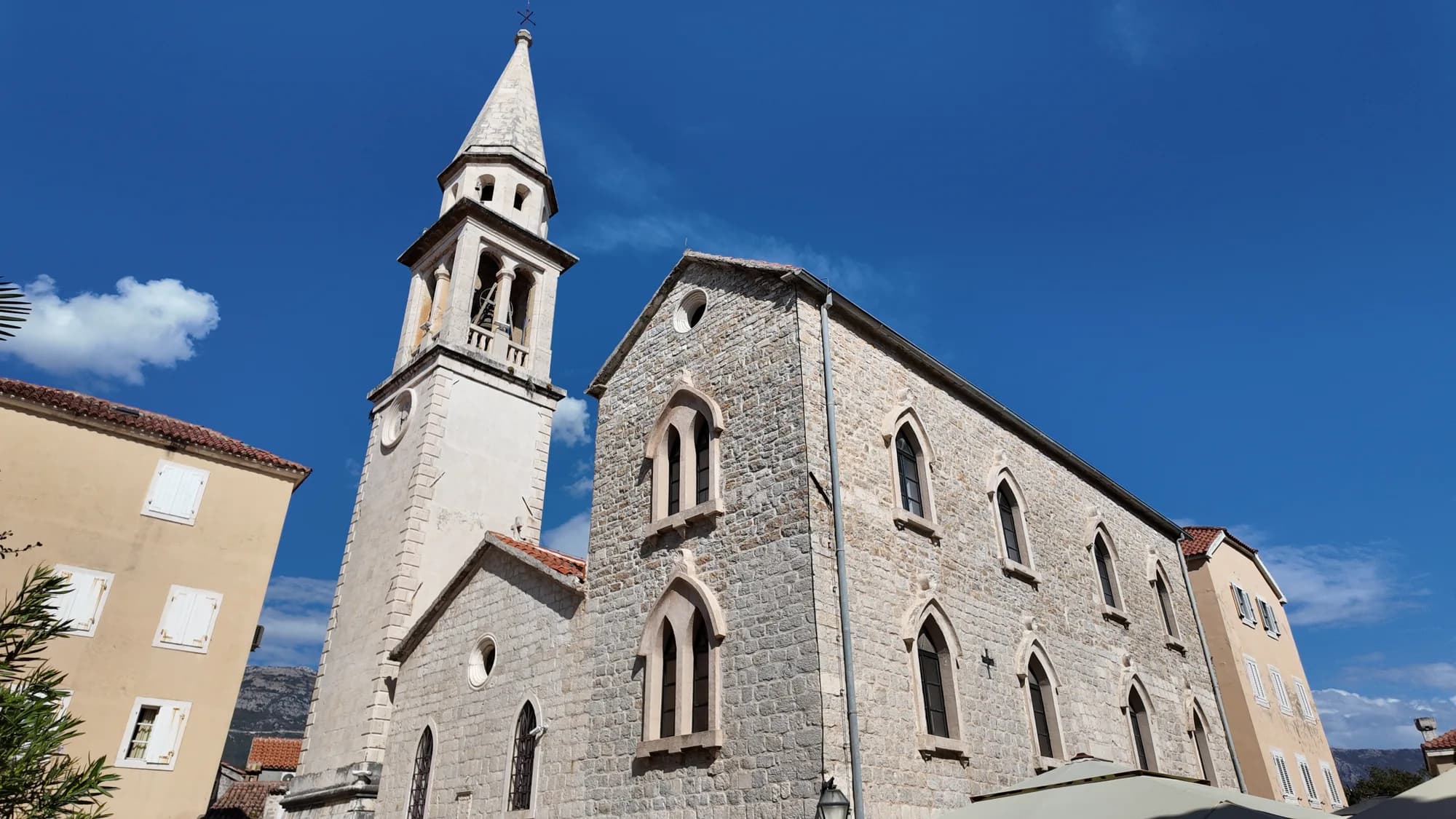 St John’s church and its bell tower in the Old Town against a deep blue sky