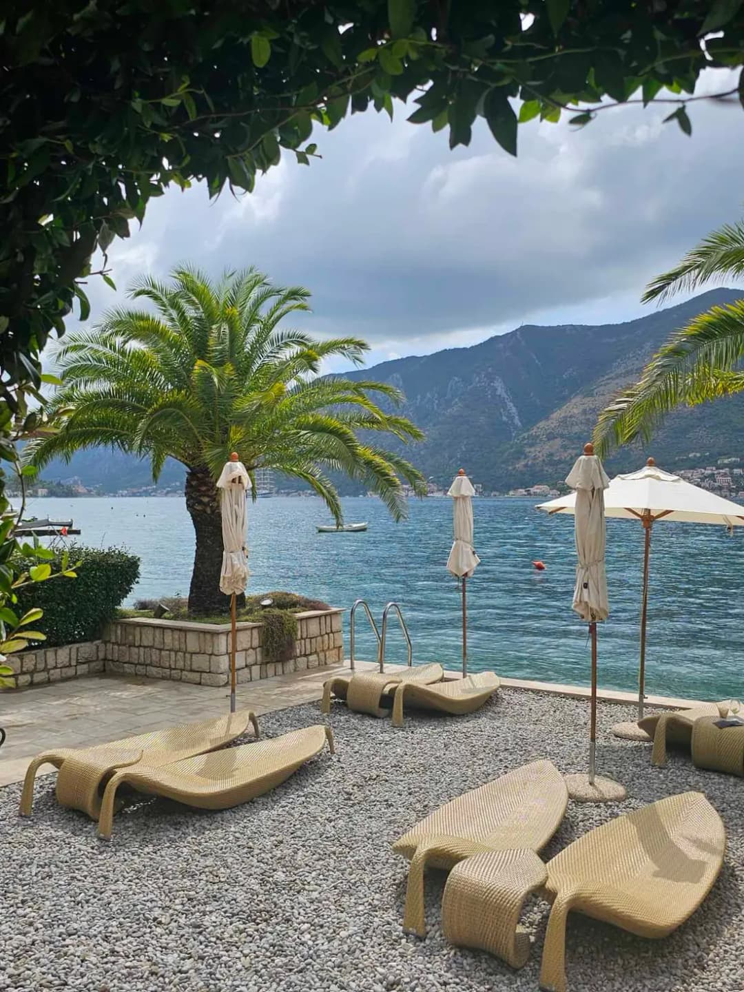 A sun terrace on Dobrota's waterfront looking out across the Bay of Kotor to the mountains opposite.