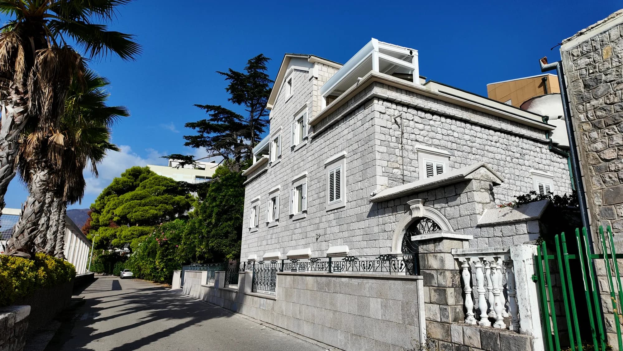 A large cut-stone house on the shore road at Kamenari