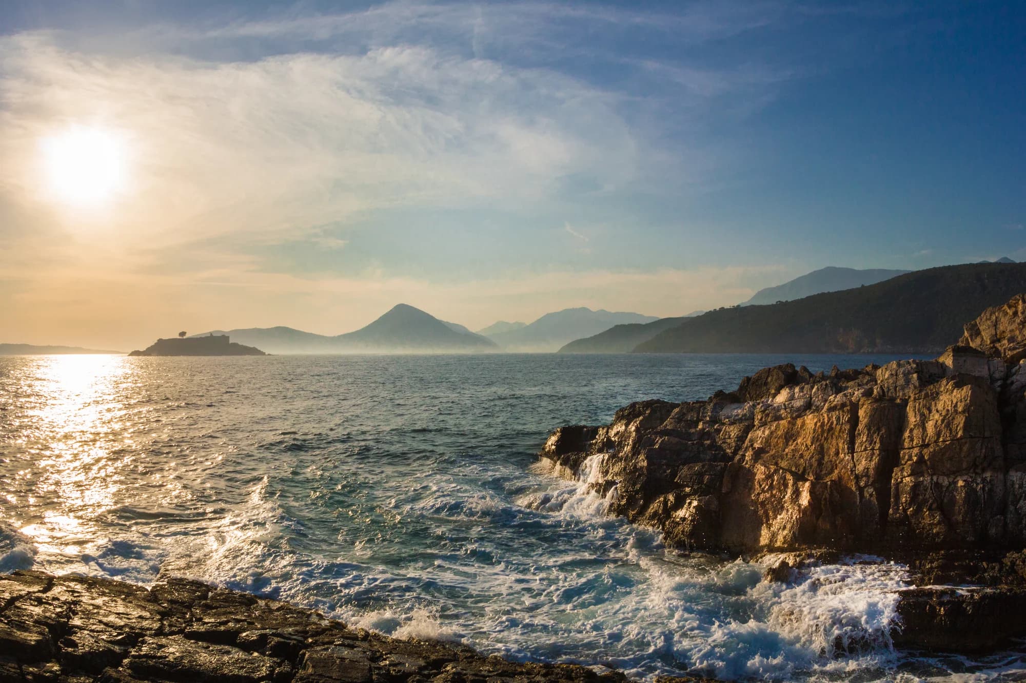 Sunset over the sea from the rocks of the Luštica shore, Mamula in silhouette