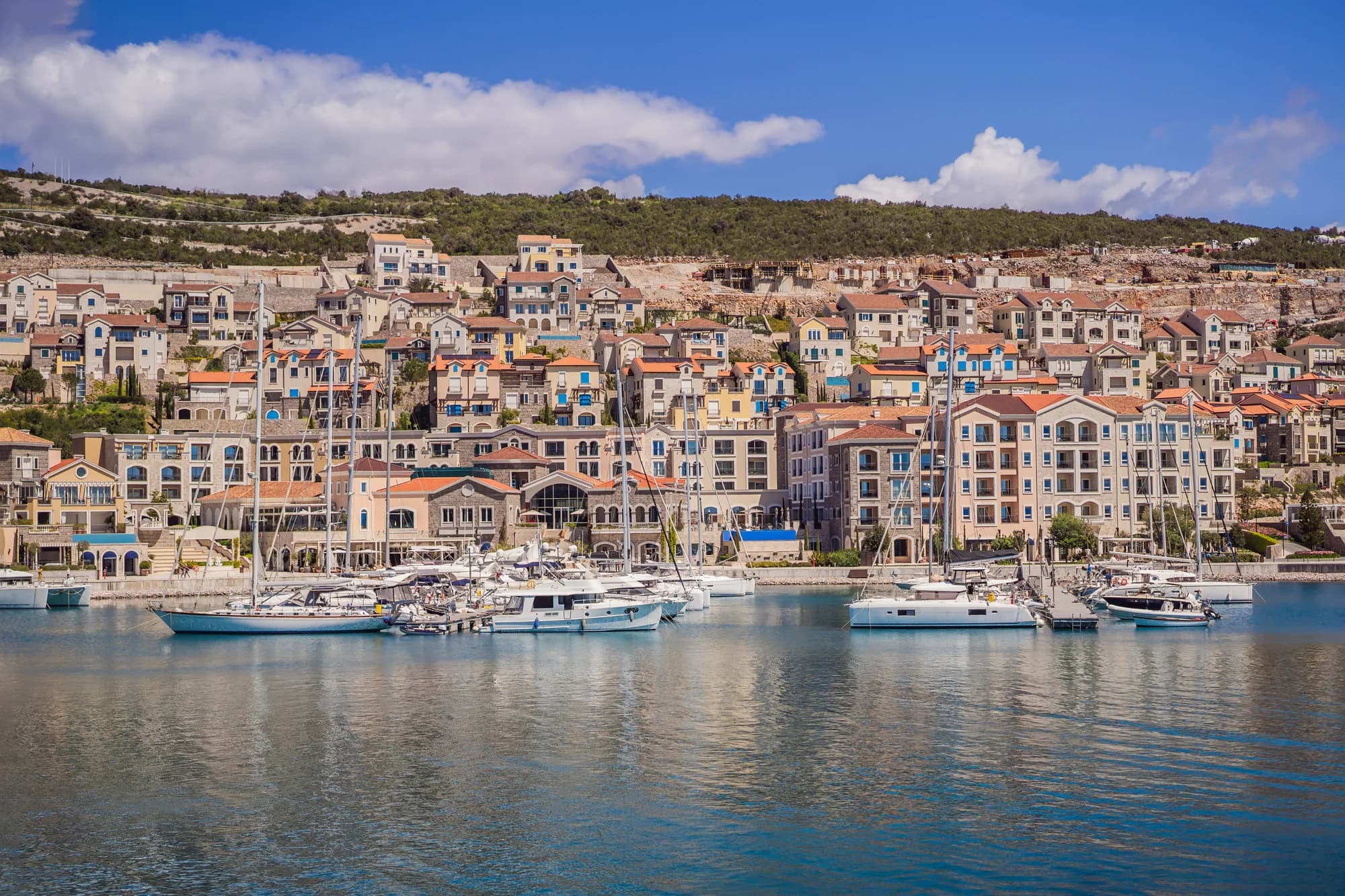 The Luštica Bay marina and its stone-and-plaster resort village, east along the coast from the beach
