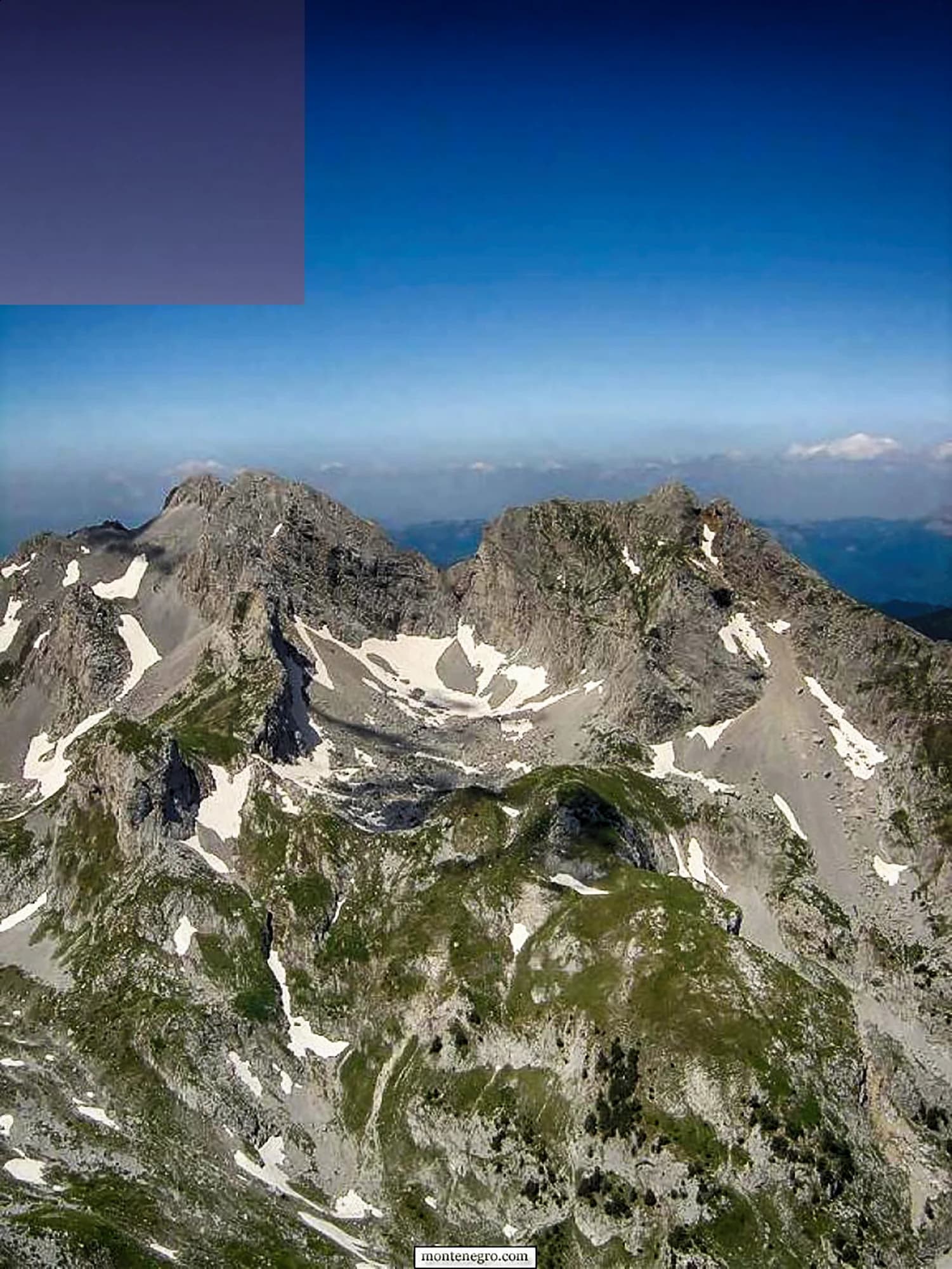The Komovi rising above the Štavna meadows