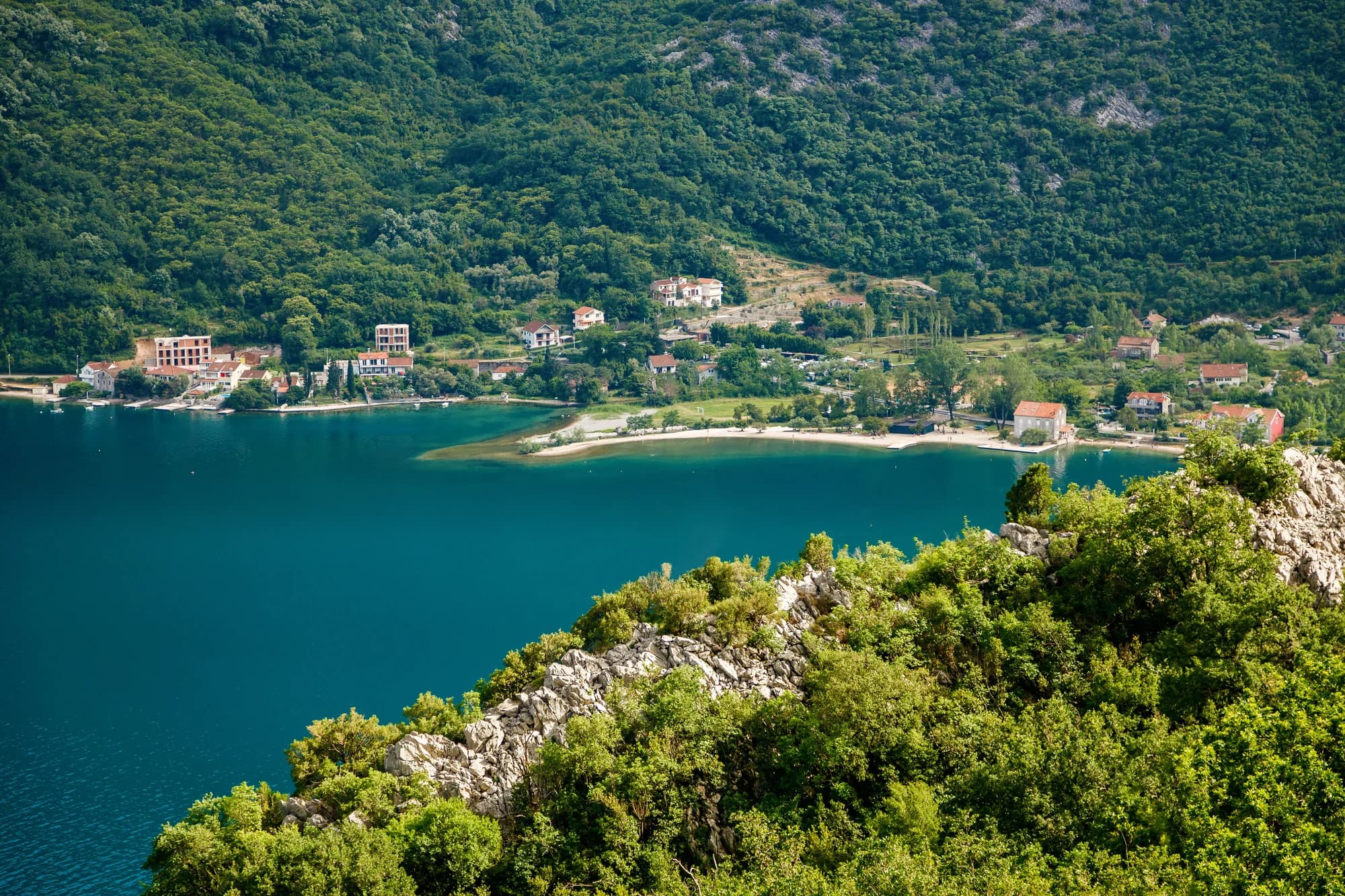 Morinj and its beach at the corner of the Risan basin from the hill, 1.7 km west of Lipci and the nearest place with a shop and a campsite