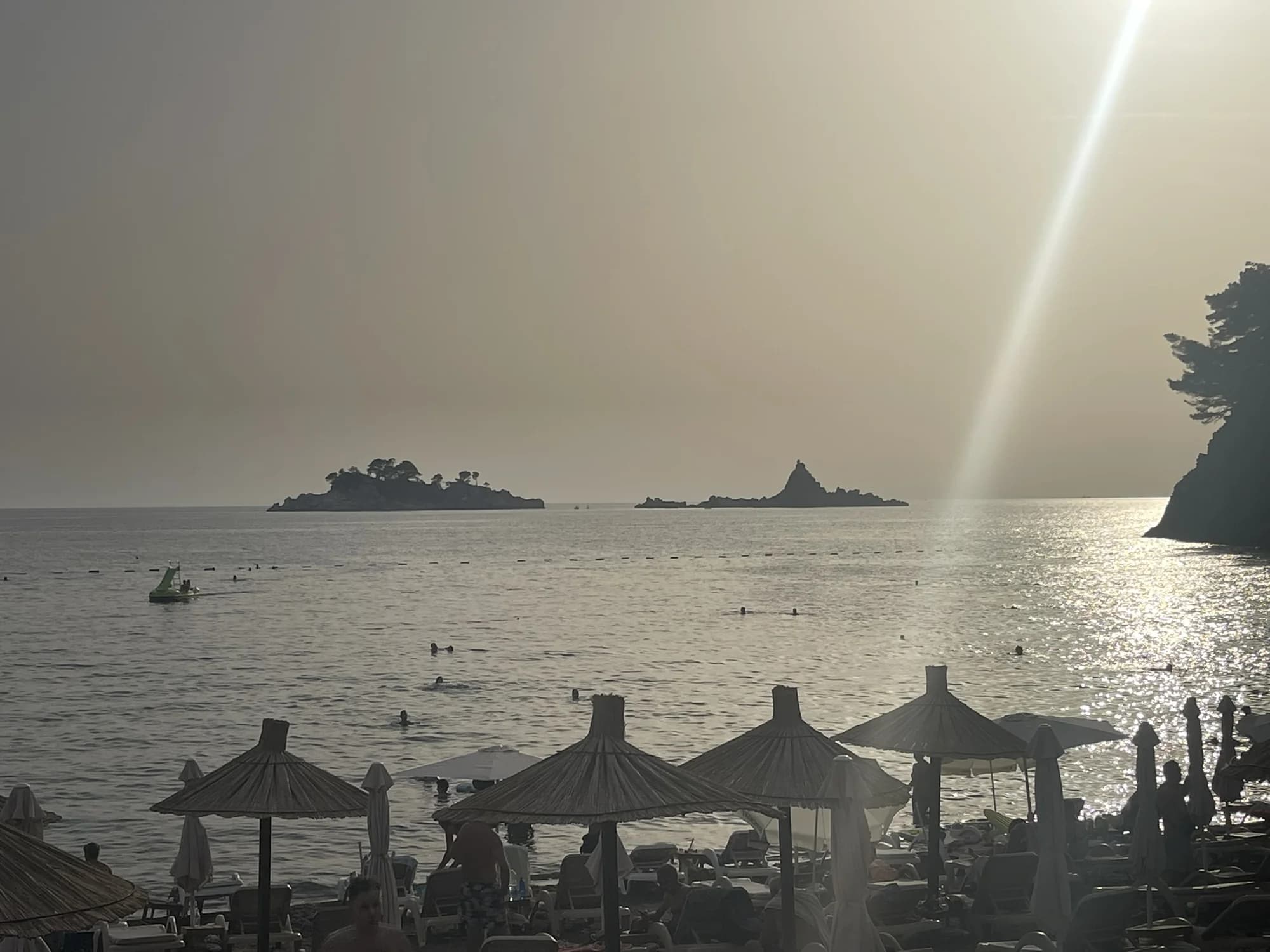 Sunset from Lučice over the thatched umbrellas, the Katič and Sveta Nedjelja islets on the horizon