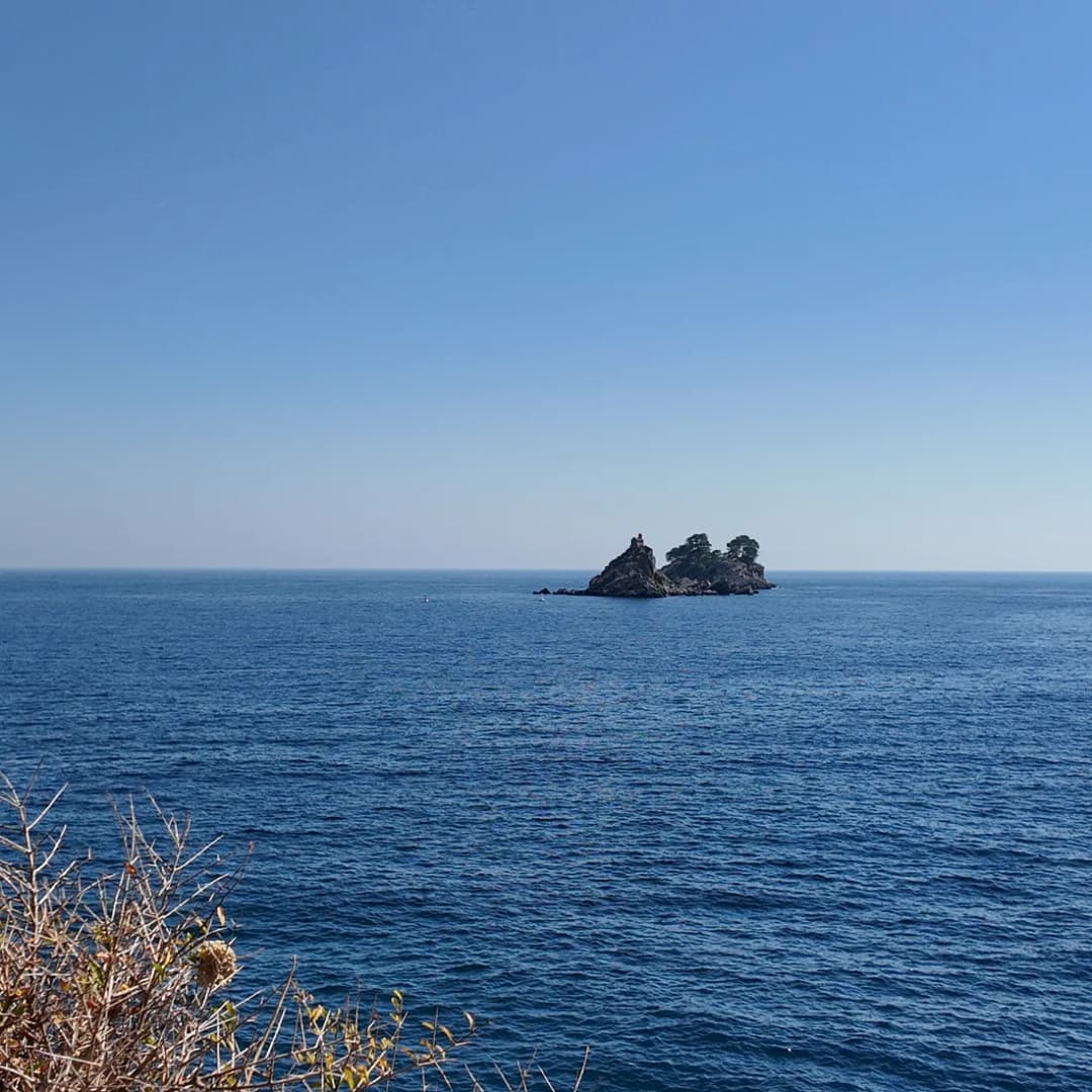 Katič islet seen offshore from a trail along the coast.