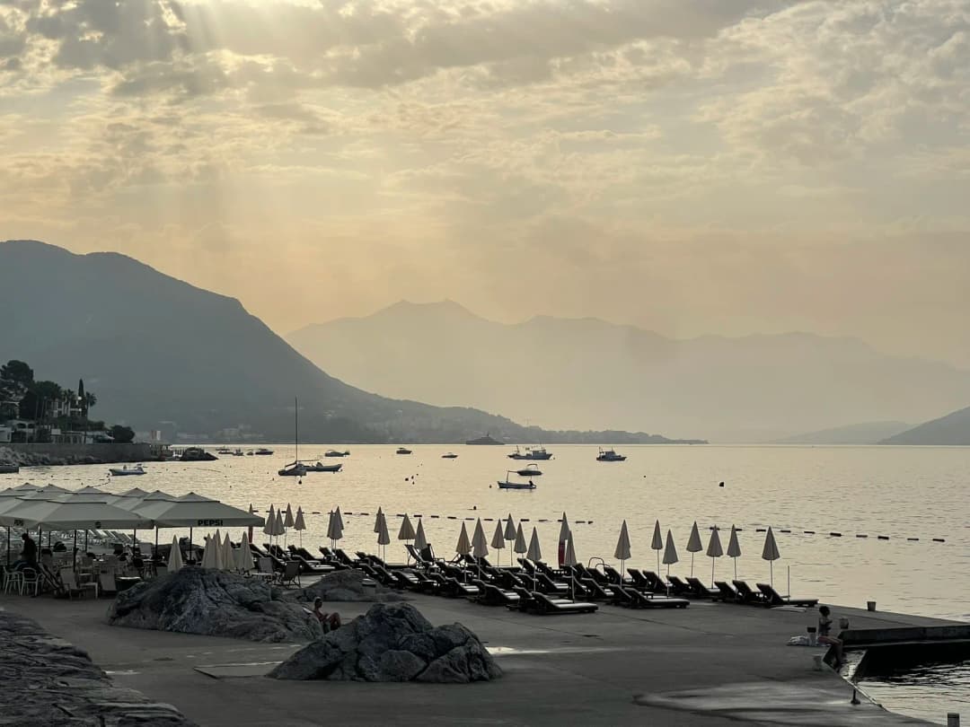 The beach club below Hotel Plaza at dawn, its sunbeds and loungers laid out along the quiet waterfront