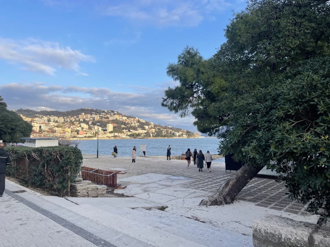 People gathered on the seafront plaza along Herceg Novi's Pet Danica promenade, the stretch used for the town's festival stalls and open-air events