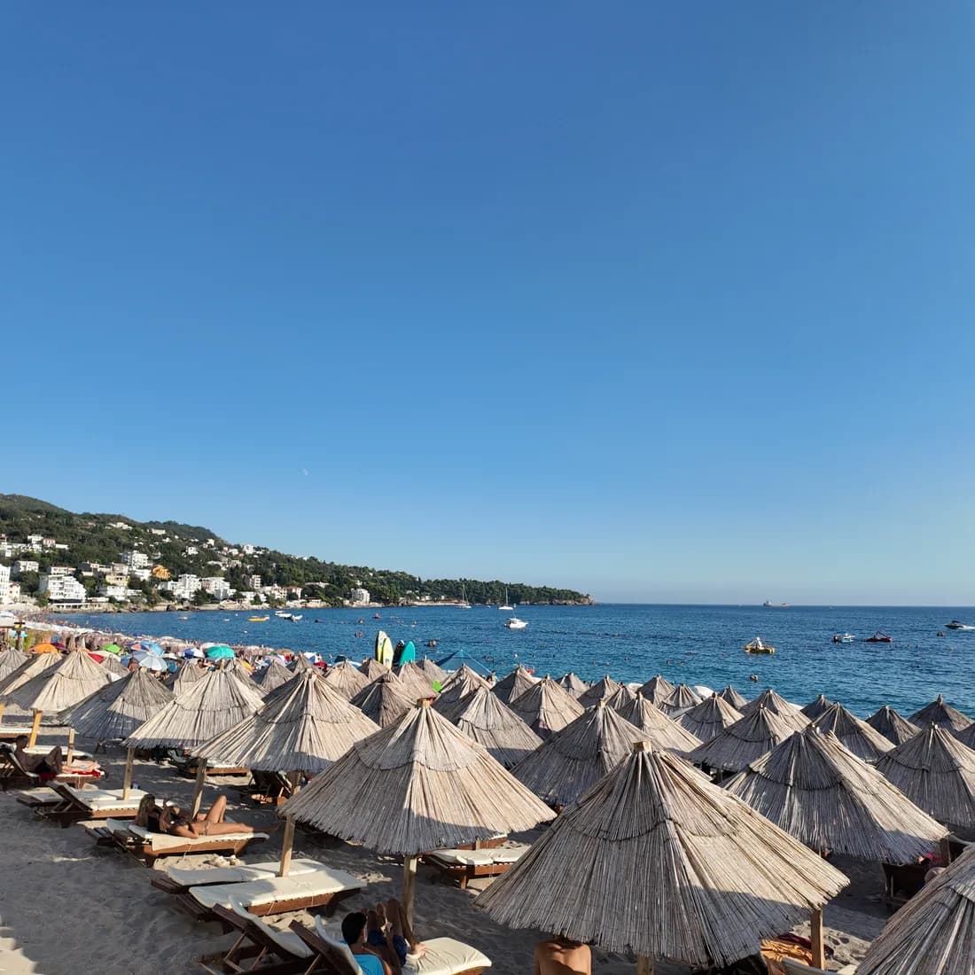 Thatched parasols in rows on the sand at Sutomore