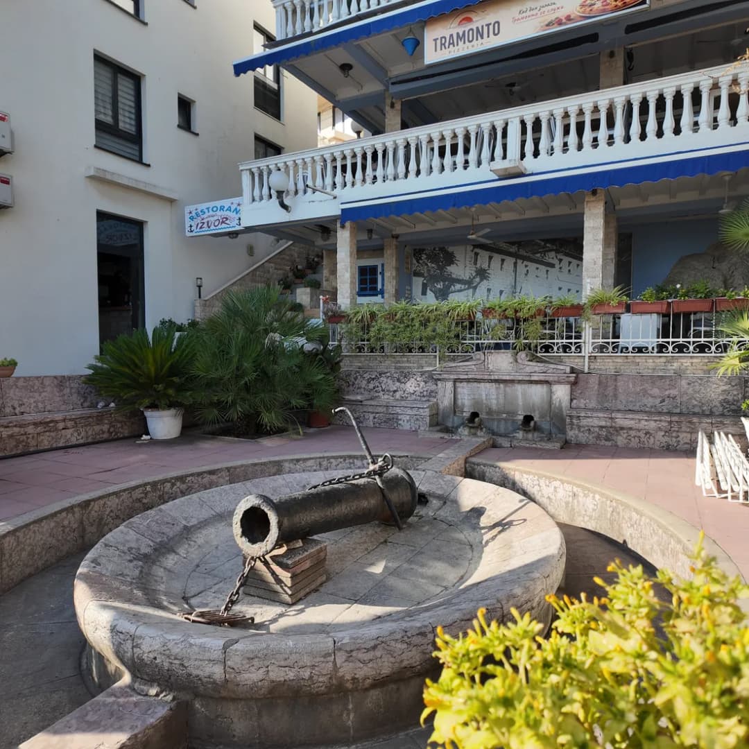 An old stone fountain set among weathered masonry in the old town.