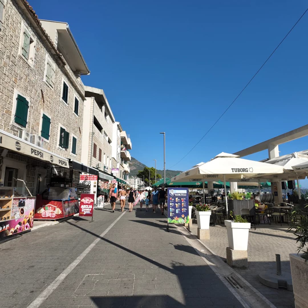 A pedestrian promenade lined with small shops and storefronts.