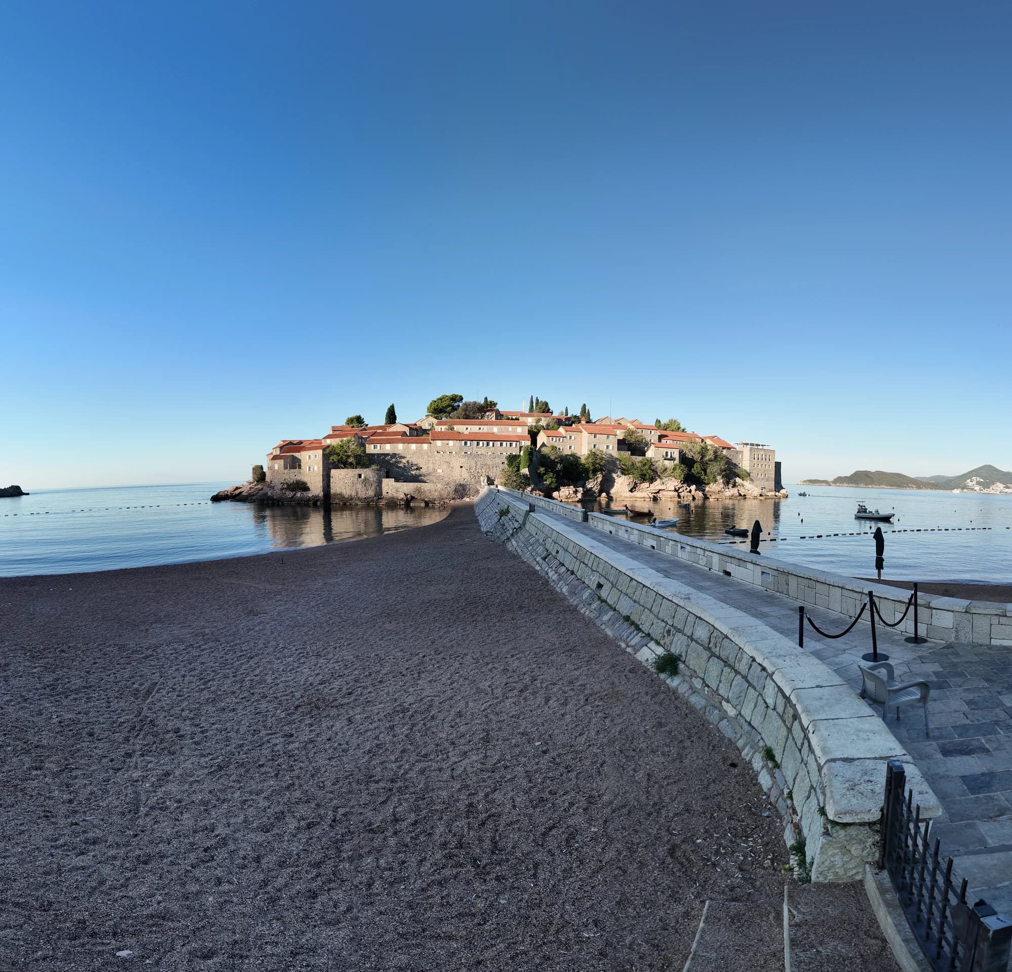The stone causeway leading from the mainland beach to the fortified islet of Sveti Stefan