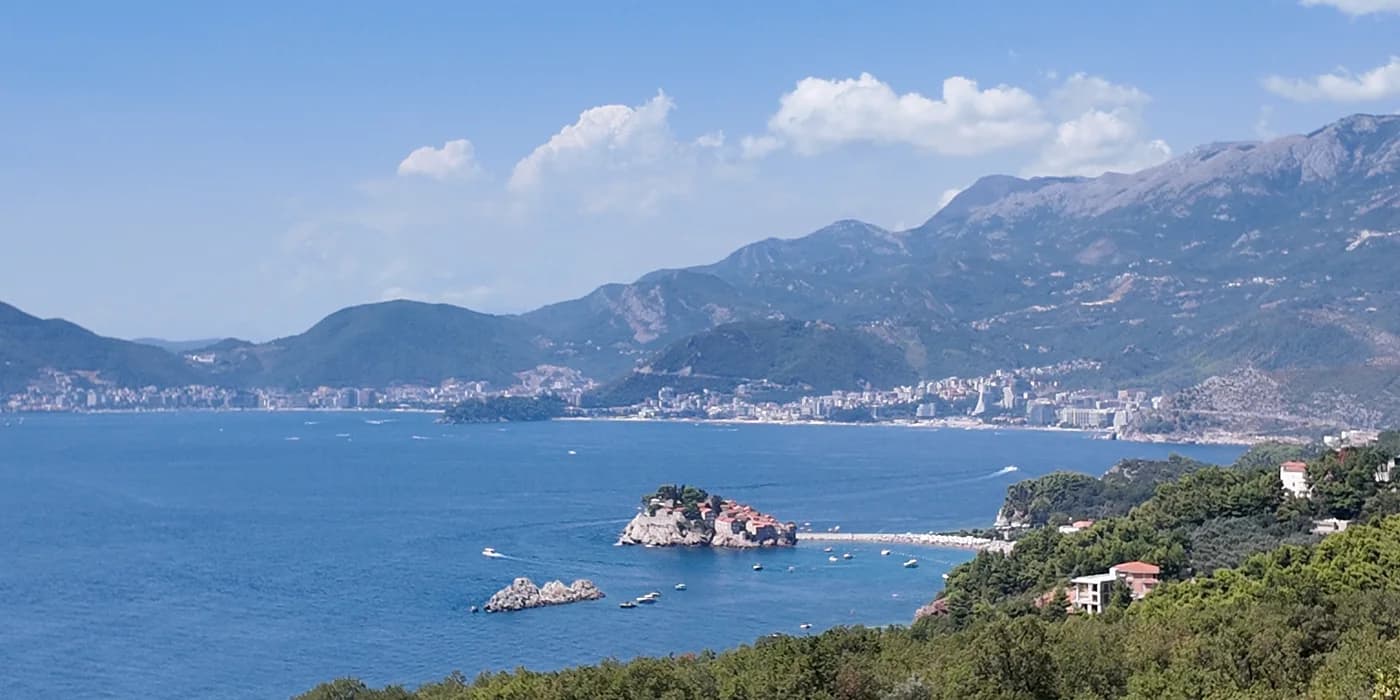 Sveti Stefan islet from above; the shore path to Miločer and Queen’s Beach leaves from the mainland end of the causeway