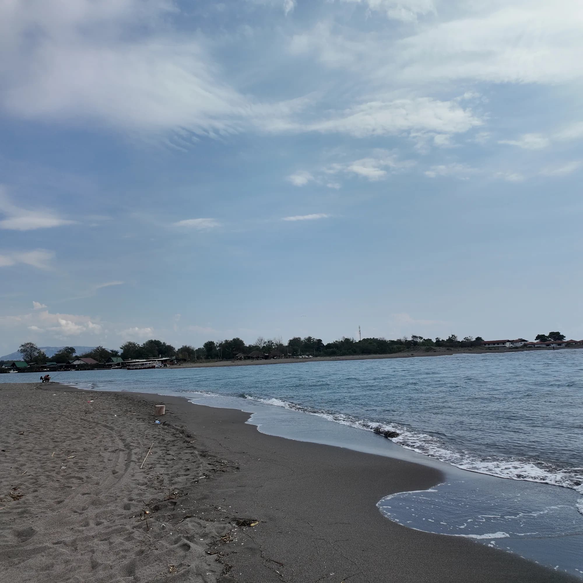 Grey sand curving away towards the Bojana mouth at the south-eastern end, on Ada Bojana across the river