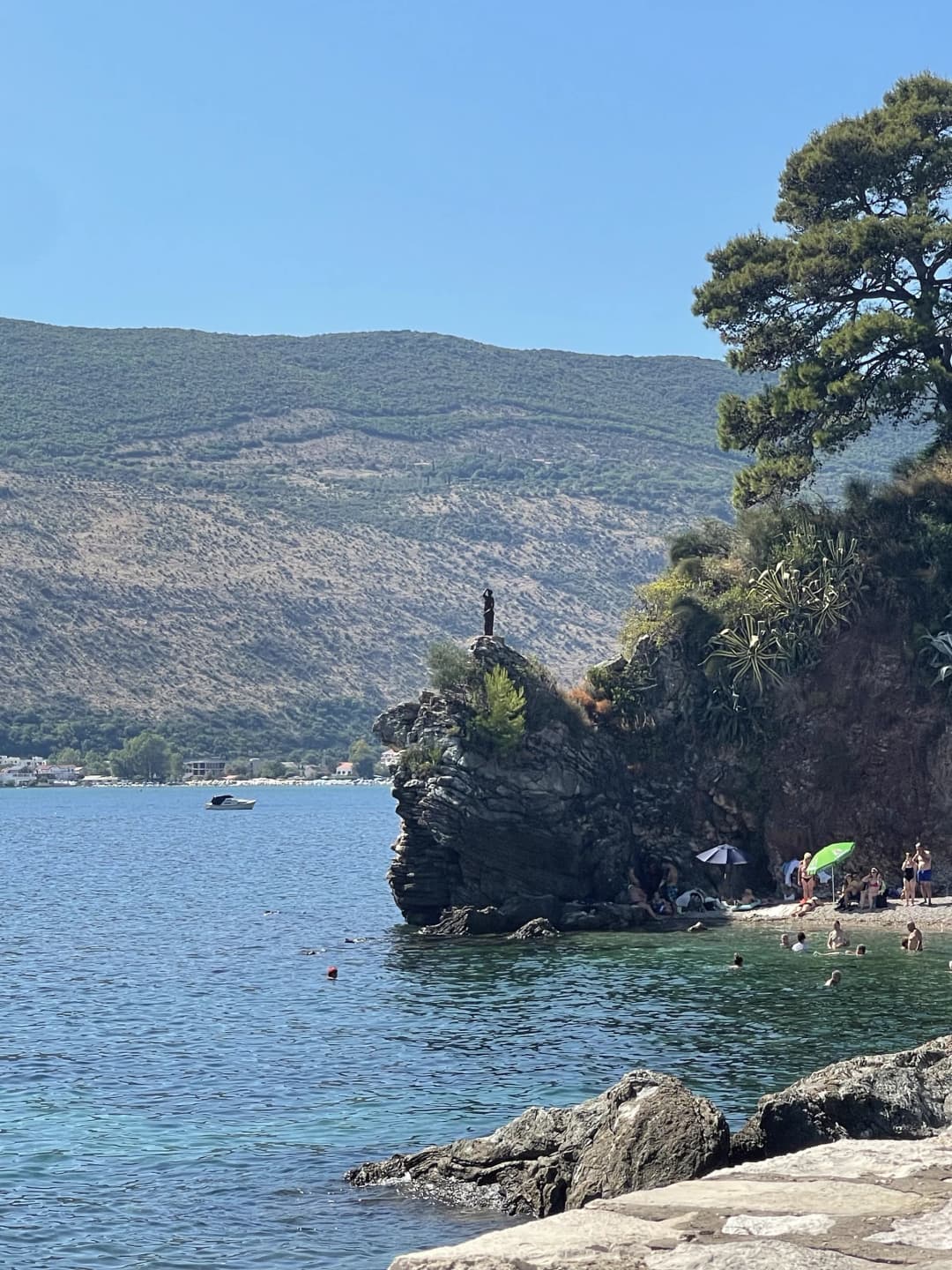 The bronze Ballerina statue on the rocks toward Mogren beach, Budva