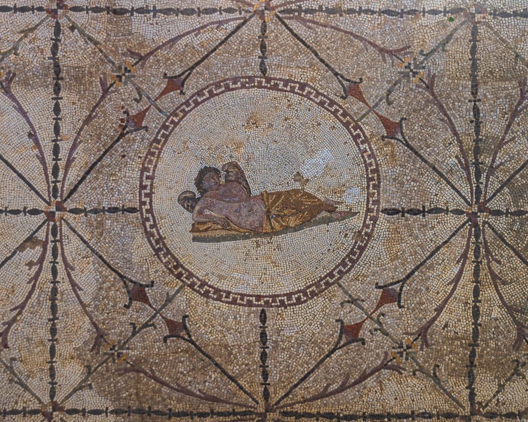 Geometric Roman mosaic floors of the Villa Urbana in Risan, preserved under a protective shelter and viewed from the visitor walkway.