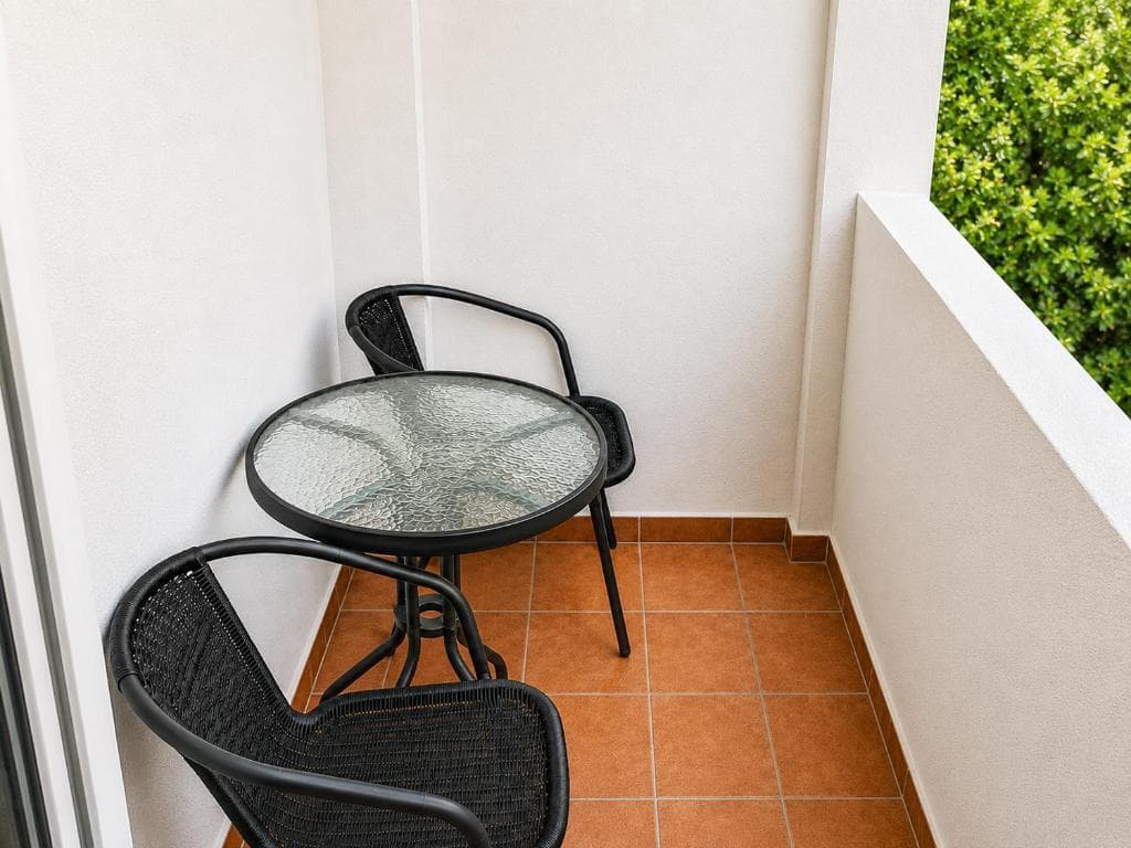 Compact balcony with bistro table at Lyon Apartmani Budva