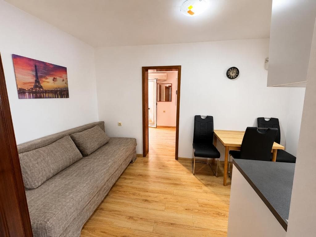 Living room with sofa and dining corner at Lyon Apartmani Budva