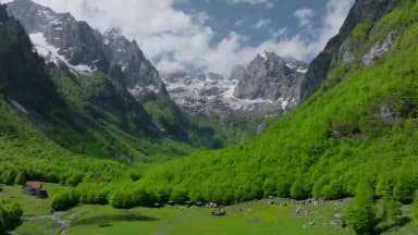 Jagged Prokletije peaks above a green valley