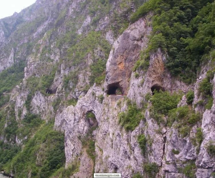 Road tunnel cut through limestone beside the Piva reservoir