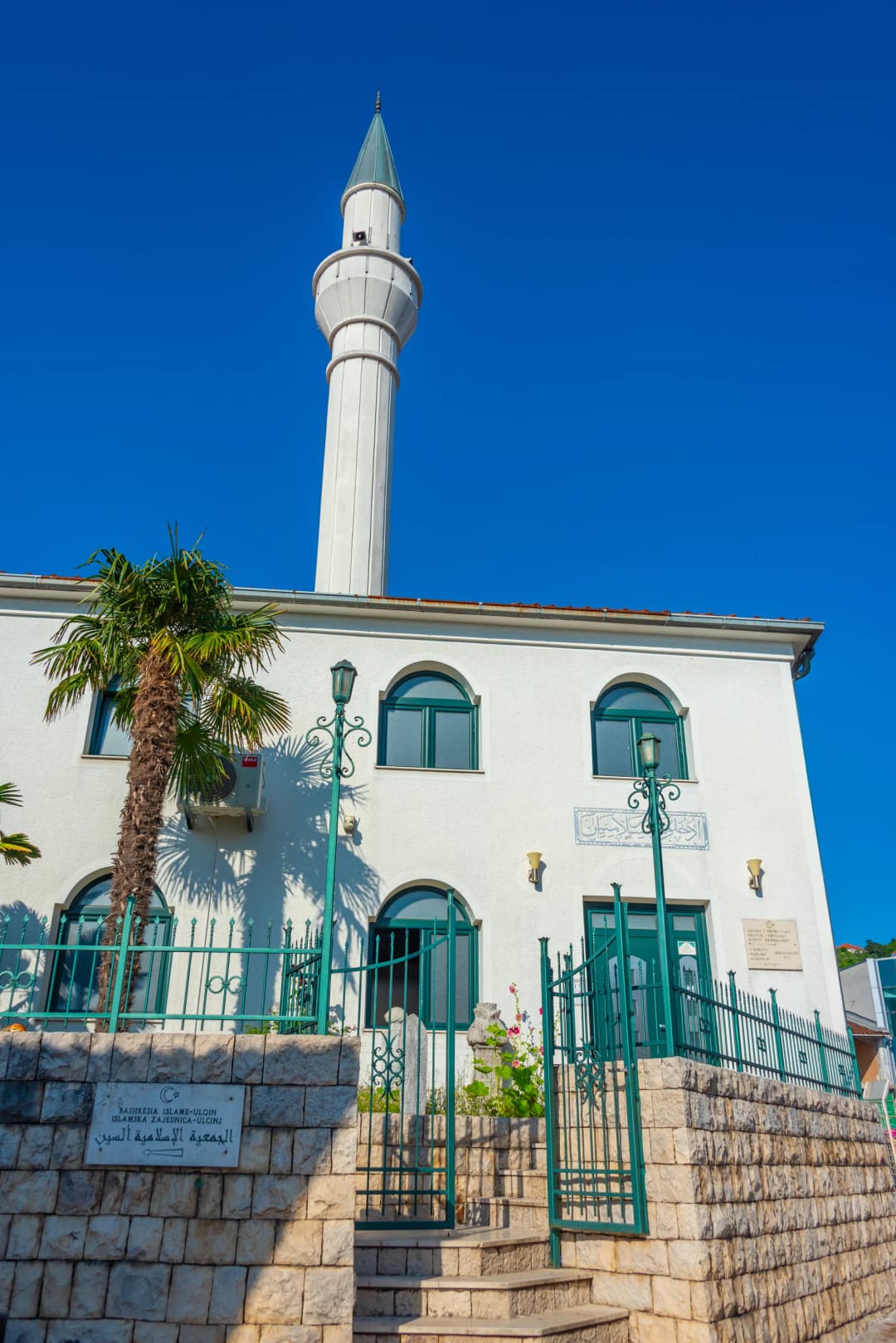 The rebuilt Sailors' Mosque of Ulcinj with its slender white minaret against a blue sky