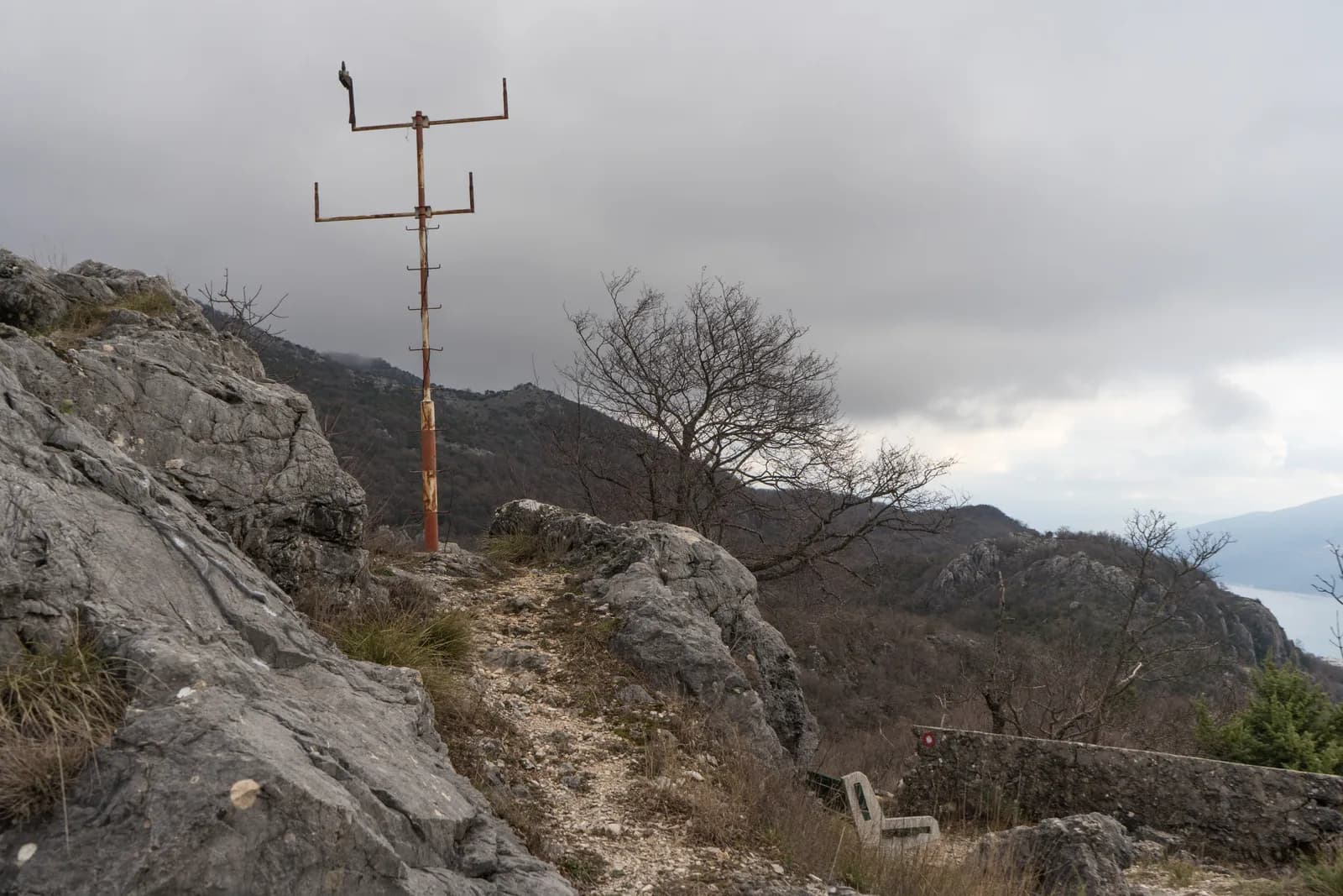 Stone and concrete military works on the wooded summit of Tajno brdo above Herceg Novi, overgrown and abandoned.
