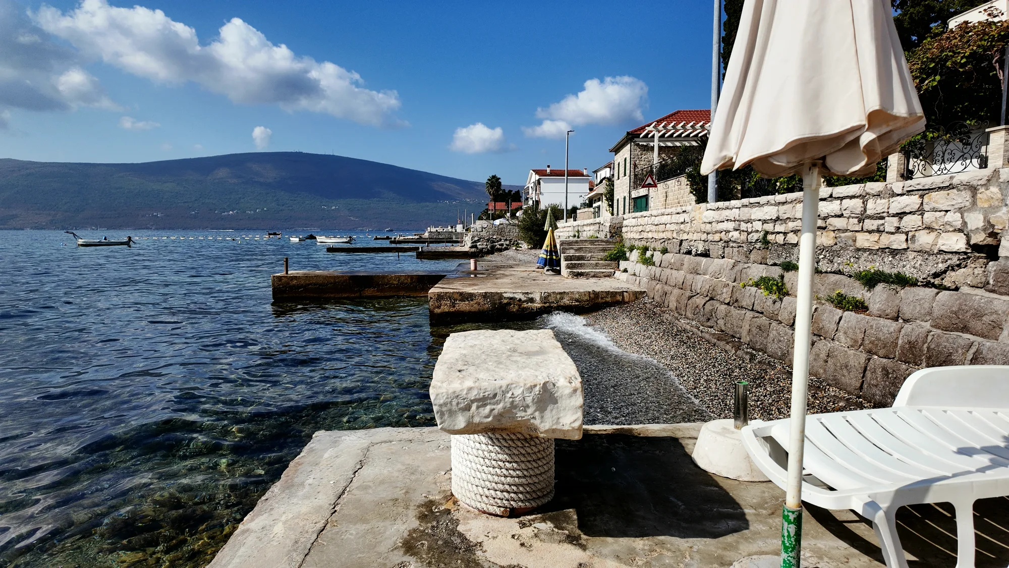 The old stone jetty at Baošići running out into the bay