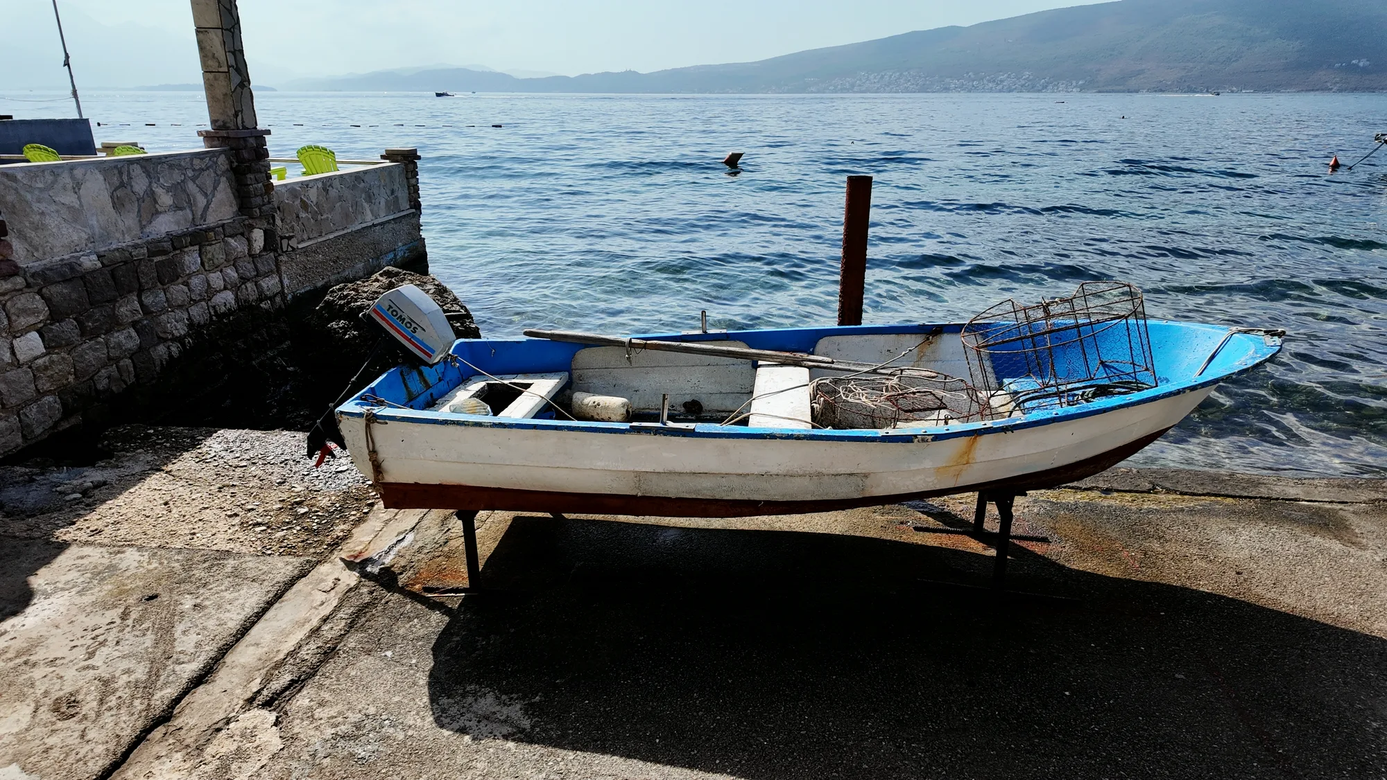 A wooden boat pulled up onto the quay at Baošići