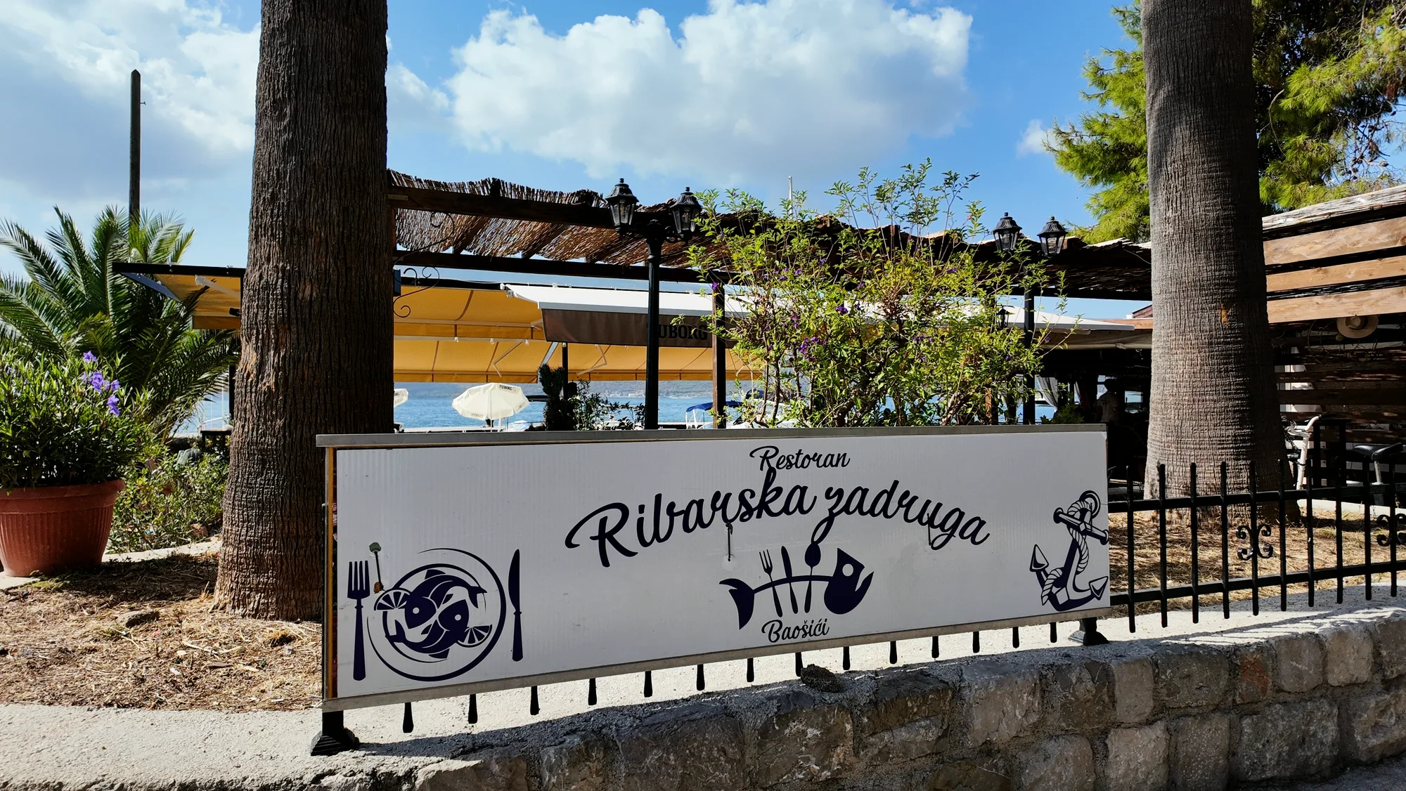 The sign of the Baošići fishermen’s cooperative on the shore road